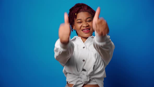 Cool Young Afro Woman Showing Thumbs Up Approves Something Blue Background