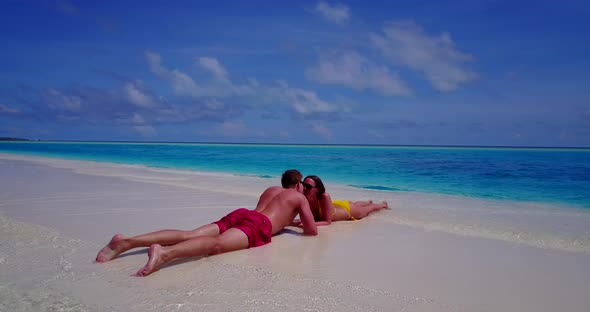 Fun couple on honeymoon vacation live the dream on beach on white sand  alt