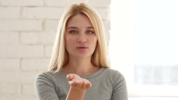 Flying Kiss Gesture by Young Woman alt
