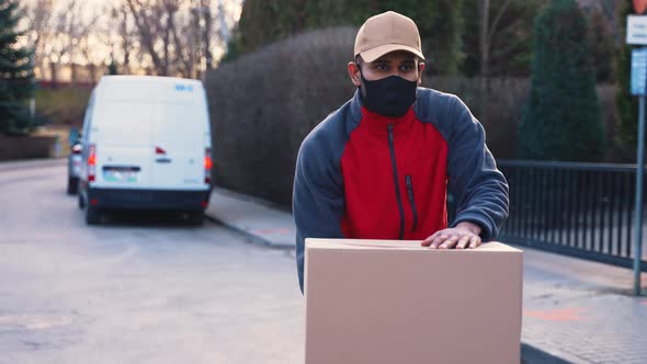 Man with Face Mask Delivering Package alt