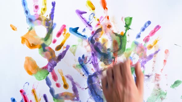 Creative Concept  Man and Woman Make Prints of Their Painted Hands on a White Background alt