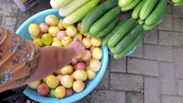Picking and buying passionfruit at the local fruit and vegetable produce market on a tropical island alt