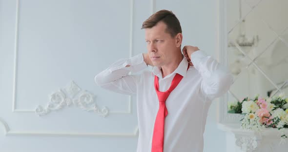 Groom Straightens His Tie  Man Tying His Tie  Groom Tying His Tie  Wedding Groom Accessories alt