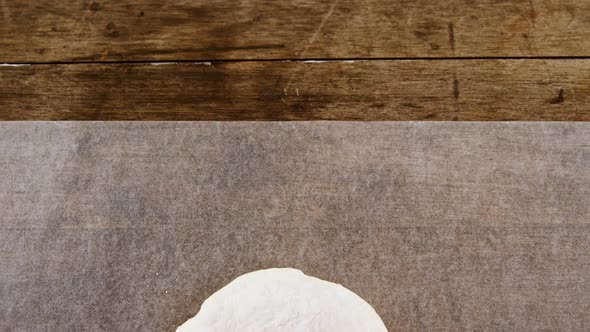 Dough ball pressed on butter paper alt