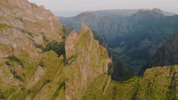 Jagged mountain peaks in rugged terrain, Pico do Areeiro trail, Madeira; drone alt