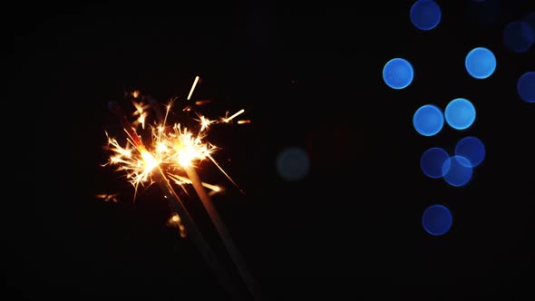Sparkler against defocused background alt