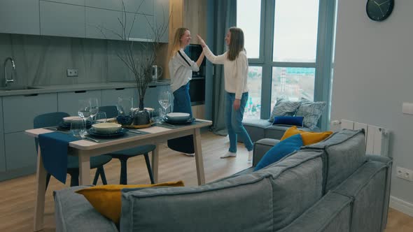 Joyous Female Designers Finishing Decoration of Apartment