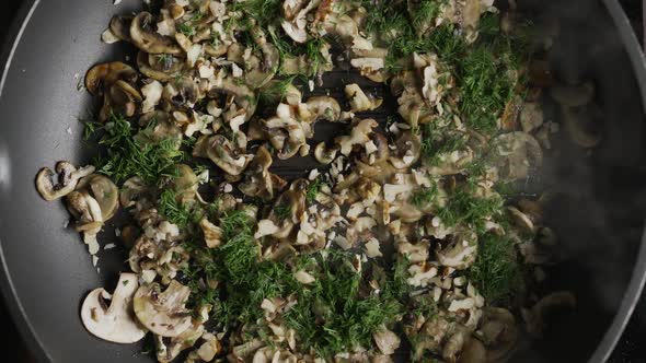 Flat Lay Shot of Champignons Are Being Roasted with Chopped Walnuts and Dill on the Grilling Pan