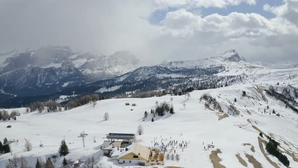 Aerial, Snowy Dolomites Mountains, Chair Lift And Mountain Hut And Skiers