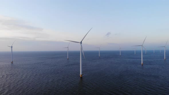 Offshore Windmill Park with Clouds and a Blue Sky Windmill Park in the Ocean Drone Aerial View with alt