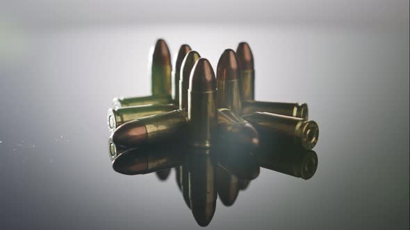 Gun Control. Ammunition of 9mm bullets rotating on a reflective surface