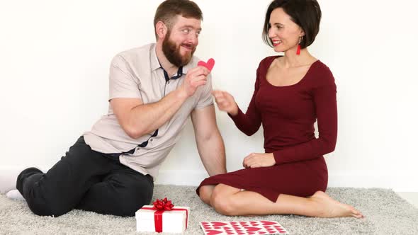 Husband and wife giving Valentines gifts.