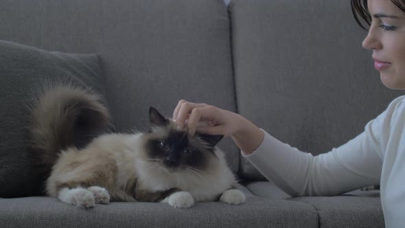 Woman cuddling her cat