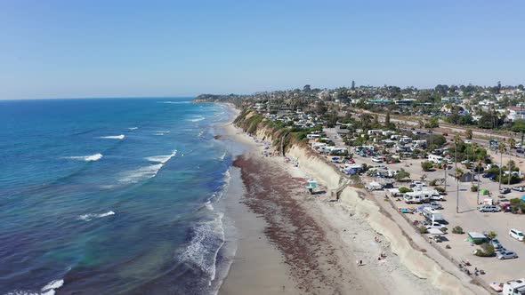 Aerial shot of a beautiful sandy beach and city on the West Coast of America alt