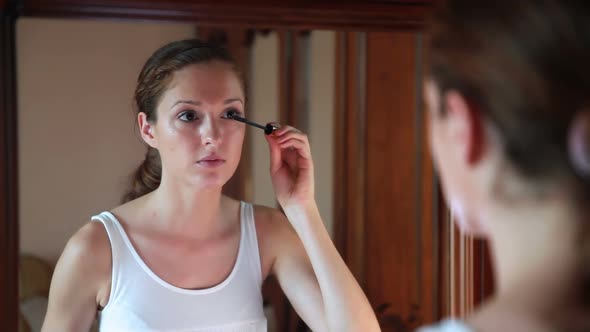 Beautiful Woman at the Mirror Applying Make Up alt