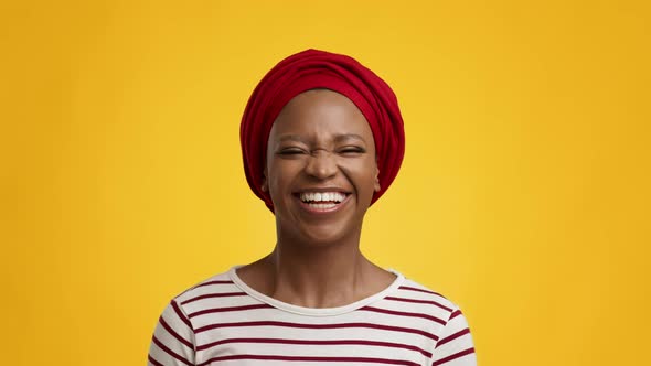 African Lady Smiling To Camera Wearing Red Headwrap Yellow Background alt
