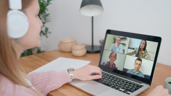 Videoconference or Online Group Video Call From Home Office. Woman Uses Laptop