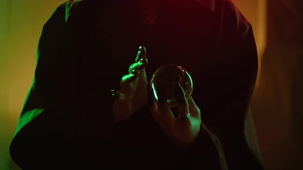 Witch Woman Holding Magic Crystal Ball Closeup alt