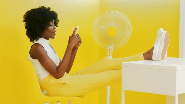 Black Woman Is Relaxing Using Gadget alt