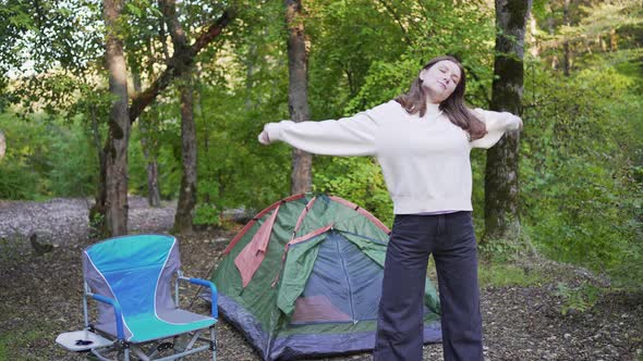 Beautiful Young Woman in the Woods Next to a Tent