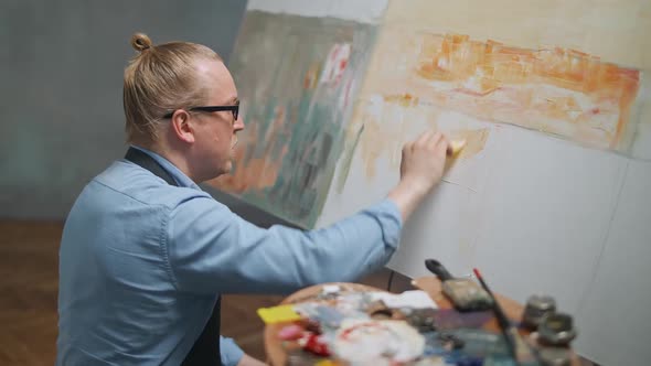 Creative Person at Work a Talented Adult Man Artist Covers the Canvas with Oil Paint Draws the alt