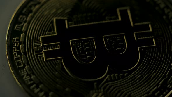 Virtual currency concept detail being illuminated and one of its sides. alt