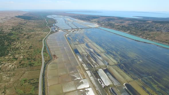 Aerial view of salt pans surrounded by sea and mountains, Pag island, Croatia alt