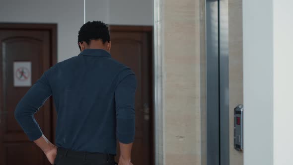 African American Businessman with Document Clipboard Encountering Creepy Zombies at Elevator alt