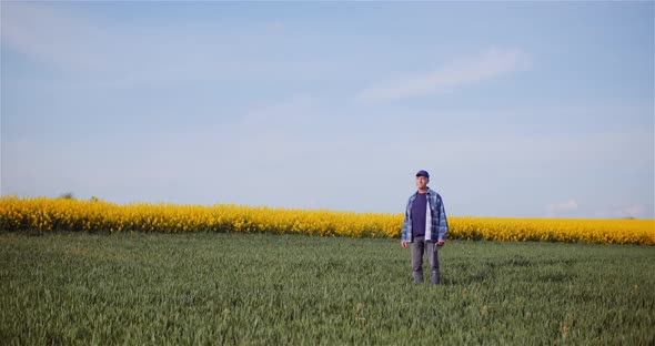 Agriculture Farmer Walking on Field. alt