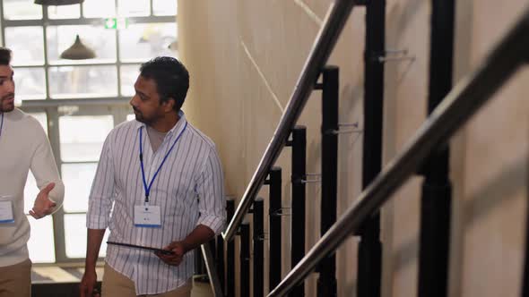 Businessmen with Name Tags Walking Upstairs alt
