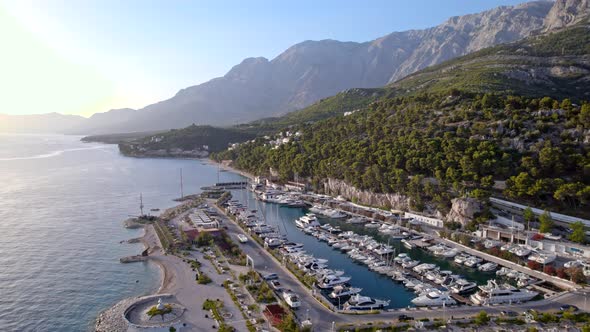 Drone  Aerial of the Marina with Yachts Near the Mountains in Sunset Light