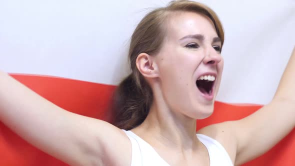 Polish Young Woman Celebrates Holding the Flag of Poland in Slow Motion alt