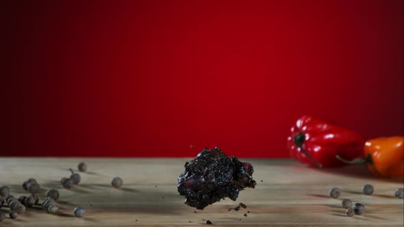 Smoked chicken wings falling and bouncing in ultra slow motion  alt