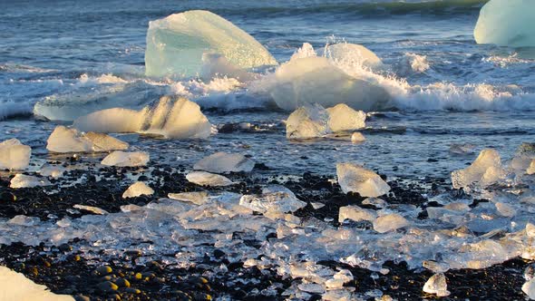 Chunks of Ice on Black Sand Global Warming Climate Change Concept Icebergs in Jokulsarlon Glacier alt