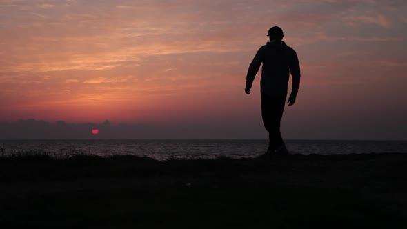 Silhouette of a Man at a Beautiful Sea Sunset
