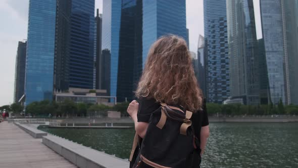Woman Tourist Enjoying Walk in Business Centre of Singapore By Marina Bay