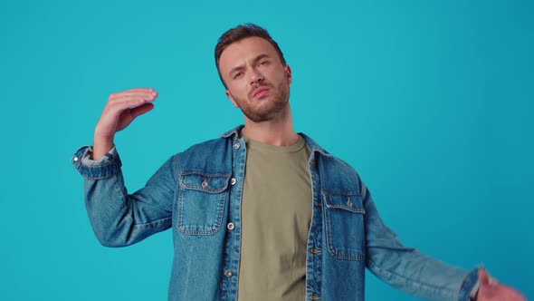 Young Man Showing Blabla Gesture Against Blue Studio Background