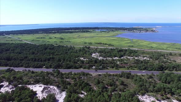 Aerial drone view of a highway near the beach alt