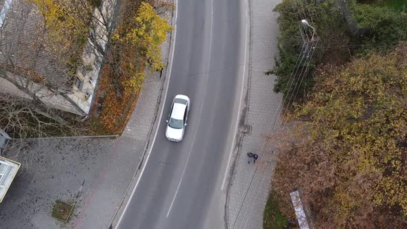Aerial view of a drone flying over the road. alt