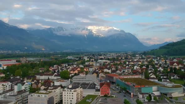Scenic Mountains Towering Over Swiss Town During Sunrise In Switzerland, Europe. Aerial Wide Shot alt