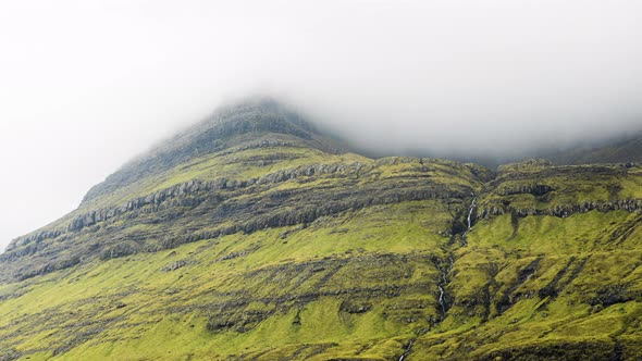 Clouds Moving Over Grassy Mountain Peak alt