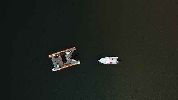 Boats in ocean top down drone view angle with beautiful blue sea color HD 30p alt