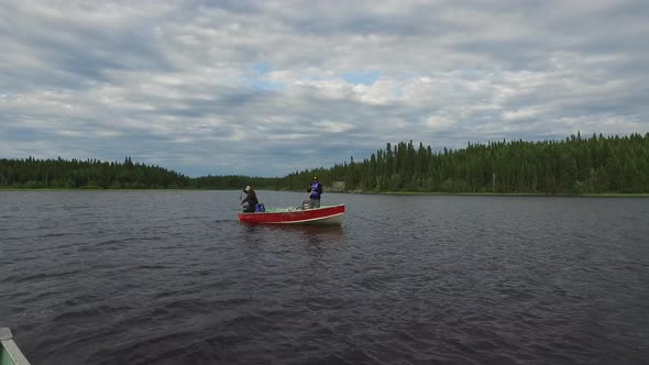 Two men fishing in a boat alt