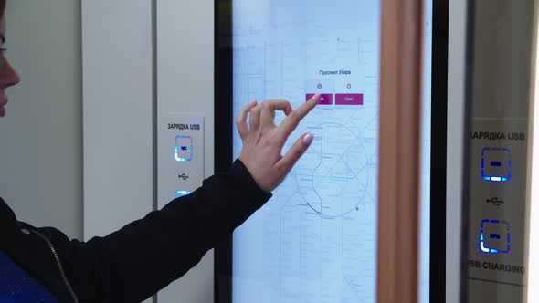 Woman is Touching the Interactive Metro Map and Choosing the Station Shodnenskaya in Russian