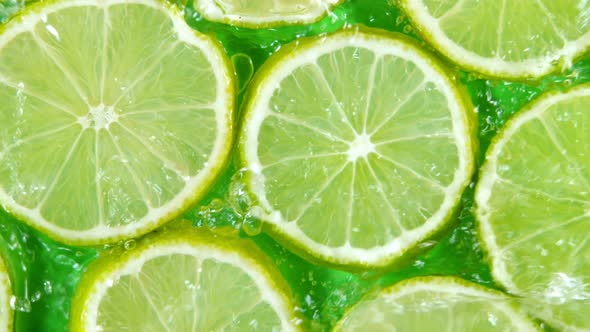 Super Slow Motion Shot of Splashing Water to Lime Slices at 1000Fps alt