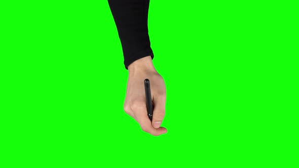 Male Hand in a Black Sweater with Liner Pen Is Writing on Green Screen Background. Close Up alt