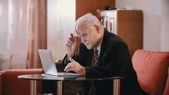 Elderly Grandfather - Old Grandfather Raises Glasses on His Forehead alt