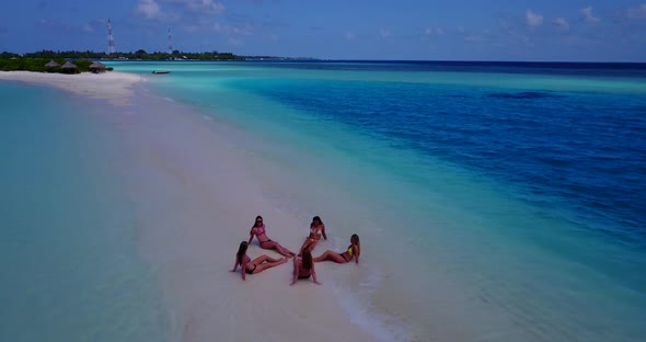 Pretty happy ladies travelling by the sea on beach on paradise white sand and blue background  alt
