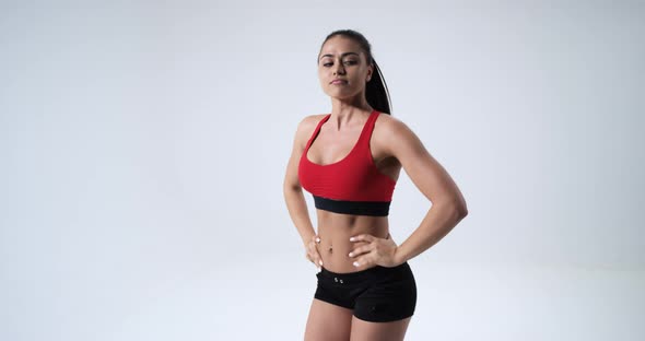 A Beautiful and Athletic Girl in Fitness Top and alt