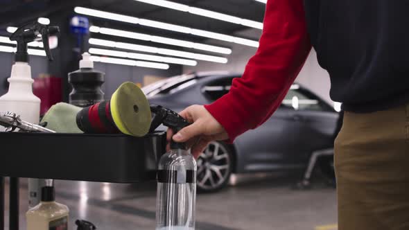 Auto Detailing Salon Man Worker Polishing Surfaces Car Other Man Takes Cleansing Spray From alt